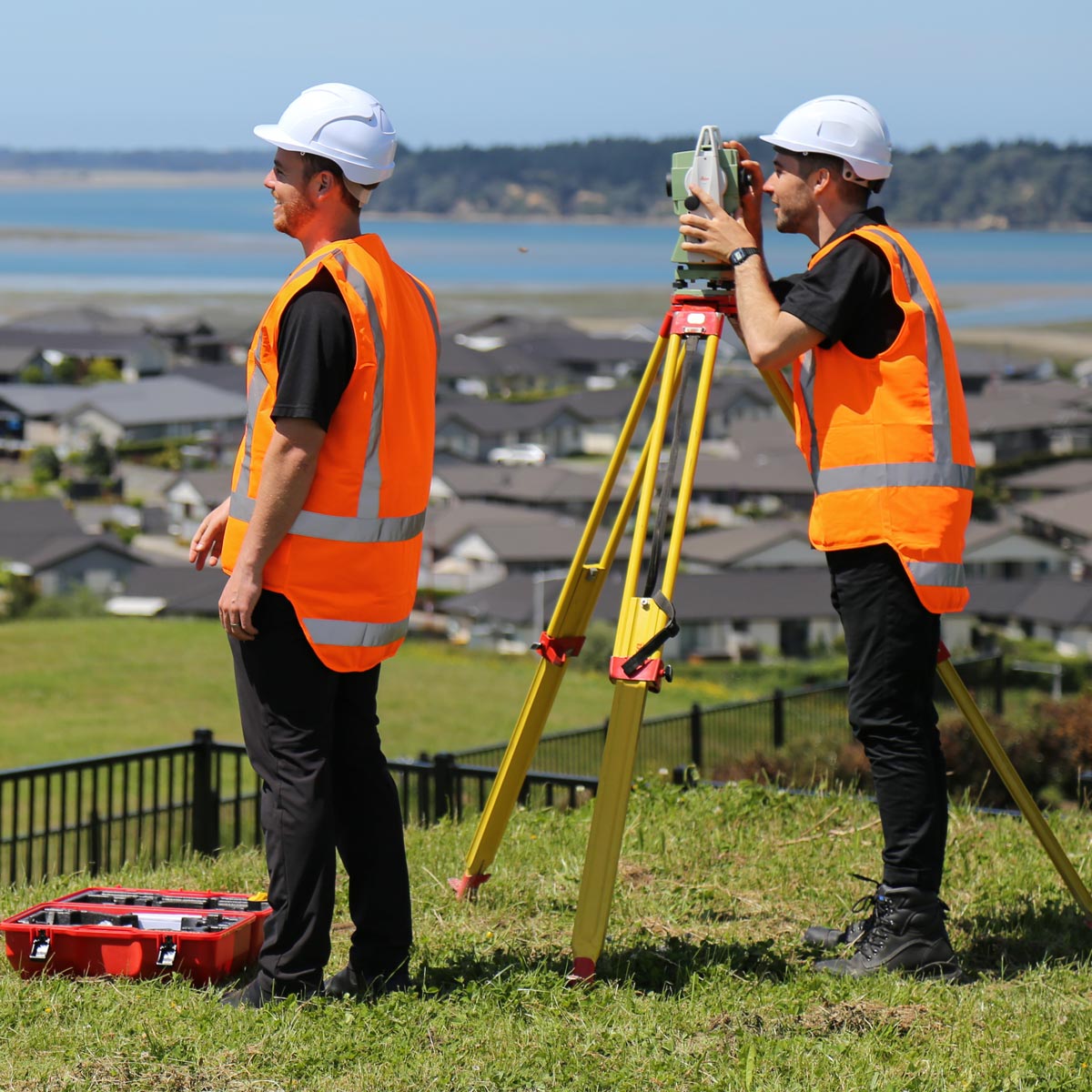 Photo of two Maven surveyors using surveying equipment on location