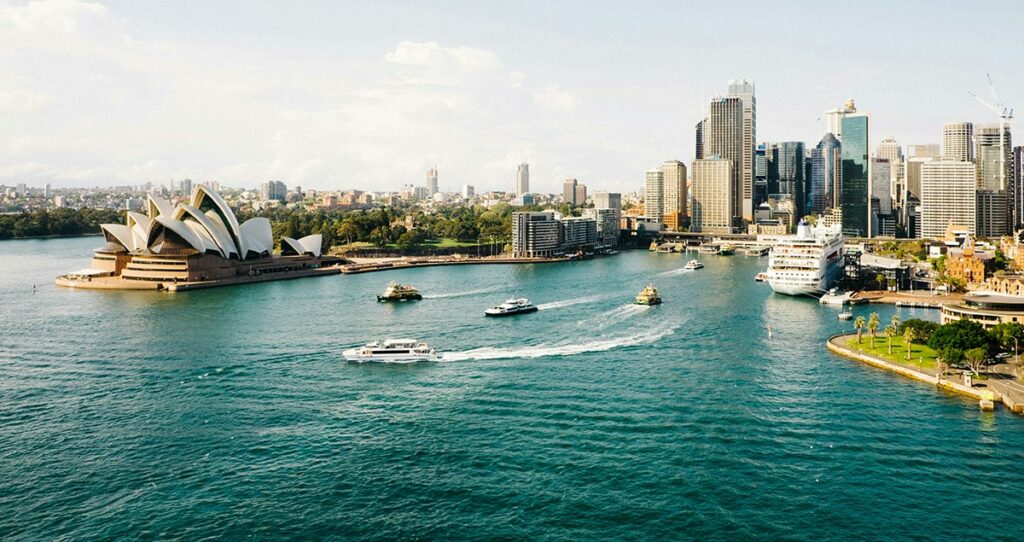 Photo of Sydney harbour, showing the Sydney Opera House and several buildings